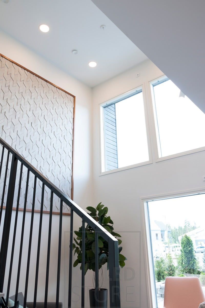 In the high ceiling, ceiling lights create general lighting and illuminate the staircase.